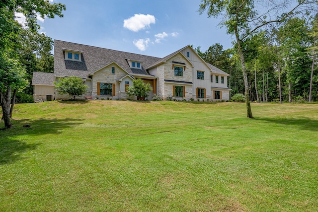 8577 Majestic Lake Ct, Montgomery, TX 77316 - view of front of property featuring stone siding, a front lawn, and roof with shingles