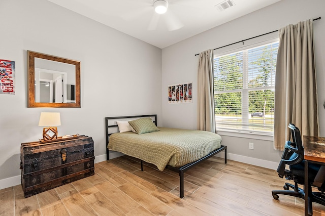 8577 Majestic Lake Ct, Montgomery, TX 77316 - bedroom featuring baseboards, light wood-type flooring, a ceiling fan, and a desk