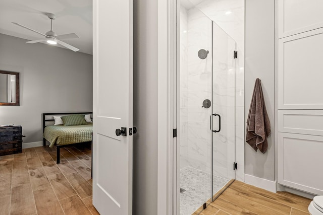 8577 Majestic Lake Ct, Montgomery, TX 77316 - ensuite bathroom featuring wood finished floors, a marble finish shower, baseboards, and ceiling fan