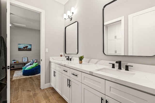 8577 Majestic Lake Ct, Montgomery, TX 77316 - bathroom featuring wood finished floors, ceiling fan, double vanity, and baseboards