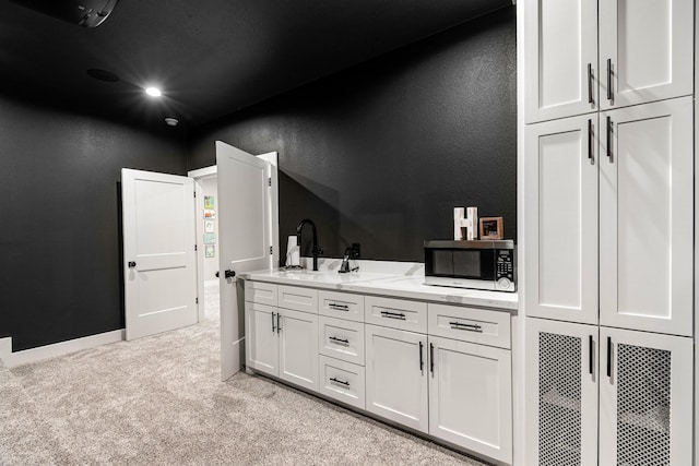 8577 Majestic Lake Ct, Montgomery, TX 77316 - bathroom with a textured wall, a sink, carpet floors, and baseboards