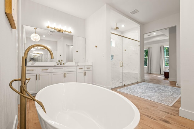8577 Majestic Lake Ct, Montgomery, TX 77316 - full bath featuring a marble finish shower, wood finished floors, a freestanding bath, vanity, and recessed lighting