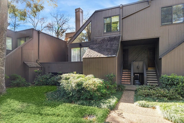 167 Litchfield Ln, Houston, TX 77024 - exterior space featuring a chimney and stairway
