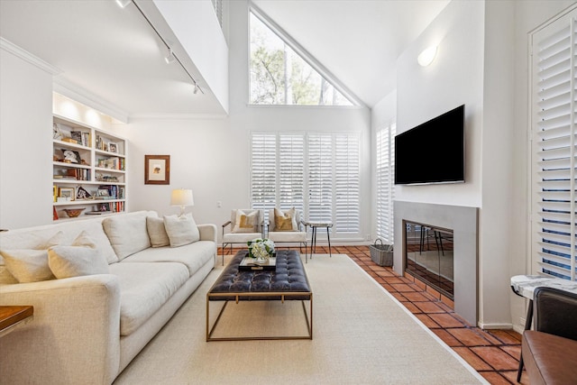 167 Litchfield Ln, Houston, TX 77024 - tiled living area featuring rail lighting, vaulted ceiling, and a fireplace with flush hearth