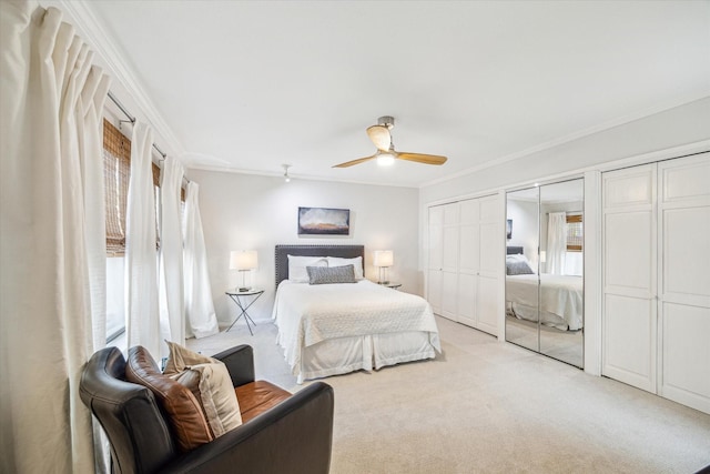 167 Litchfield Ln, Houston, TX 77024 - bedroom featuring light colored carpet, crown molding, two closets, and a ceiling fan