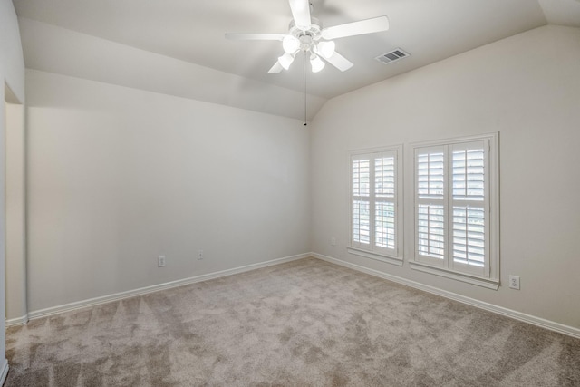 unfurnished room featuring vaulted ceiling, carpet floors, a ceiling fan, and baseboards
