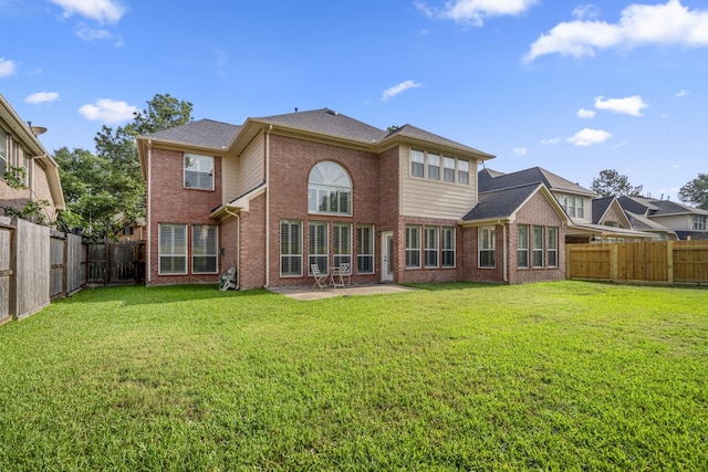back of house featuring brick siding and a patio