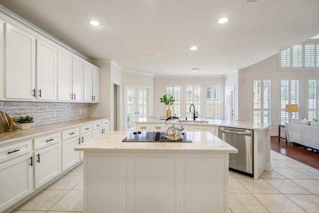 kitchen with dishwasher, a center island, black electric cooktop, a sink, and light tile patterned floors