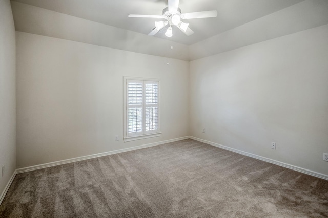 unfurnished room with carpet flooring, a ceiling fan, baseboards, and lofted ceiling