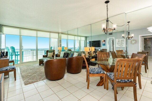 1401 E Beach Dr Unit 811, Galveston, TX 77550 - dining space featuring a wealth of natural light, a chandelier, and light tile patterned floors