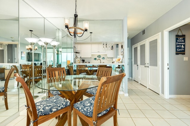 1401 E Beach Dr Unit 811, Galveston, TX 77550 - dining space with baseboards, a notable chandelier, light tile patterned floors, and visible vents
