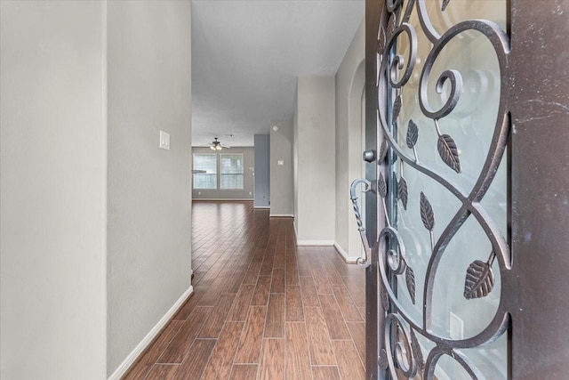 entryway with baseboards, ceiling fan, and wood finished floors
