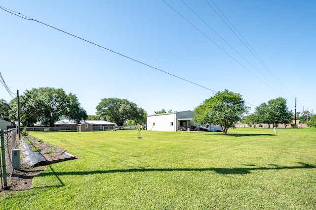 view of yard with an outbuilding and fence
