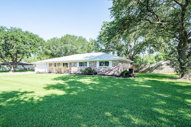 single story home featuring a garage, driveway, fence, and a front yard
