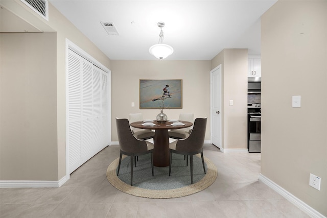 dining room with light tile patterned flooring, baseboards, and visible vents