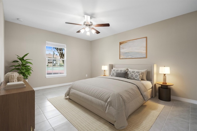 bedroom featuring light tile patterned floors, baseboards, and ceiling fan