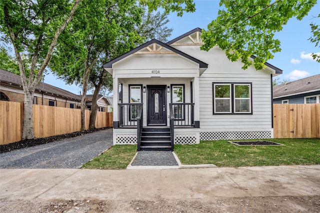 4104 Engelke St, Houston, TX 77003 - view of front facade with a porch, fence, and a front lawn