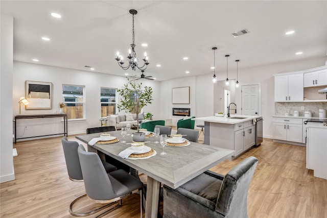 4104 Engelke St, Houston, TX 77003 - dining area with visible vents, recessed lighting, an inviting chandelier, light wood-style flooring, and baseboards