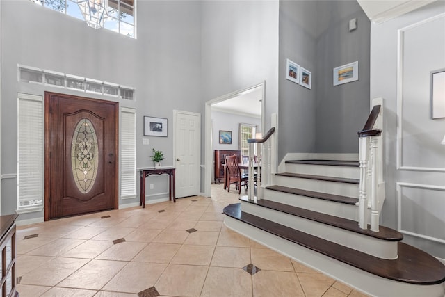 7219 Palisades Heights Dr, Houston, TX 77095 - entrance foyer featuring a high ceiling, light tile patterned floors, stairs, healthy amount of natural light, and baseboards