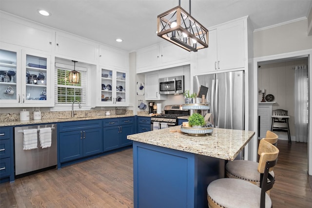 419 E Bell Ave, Crockett, TX 75835 - kitchen with a breakfast bar area, blue cabinets, a sink, stainless steel appliances, and white cabinets
