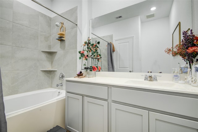 bathroom featuring vanity, bathtub / shower combination, and visible vents