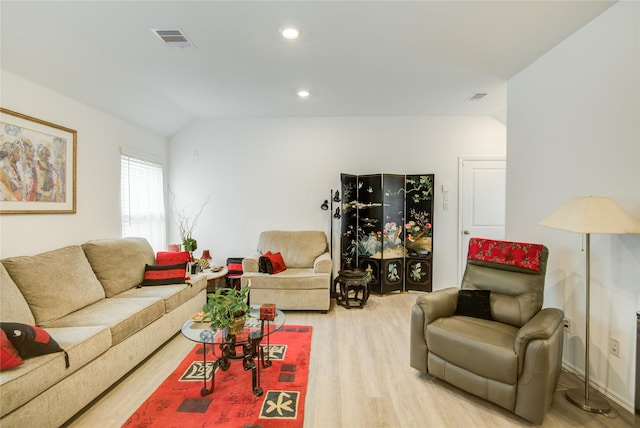 living area with lofted ceiling, recessed lighting, visible vents, and wood finished floors