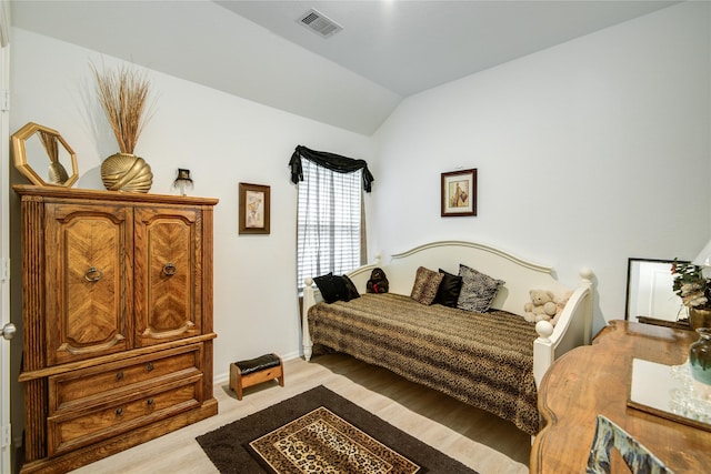 bedroom with visible vents, baseboards, and lofted ceiling