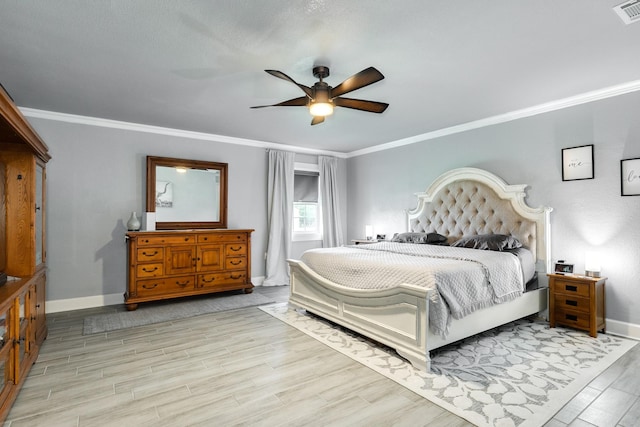 bedroom featuring crown molding, wood finished floors, and baseboards