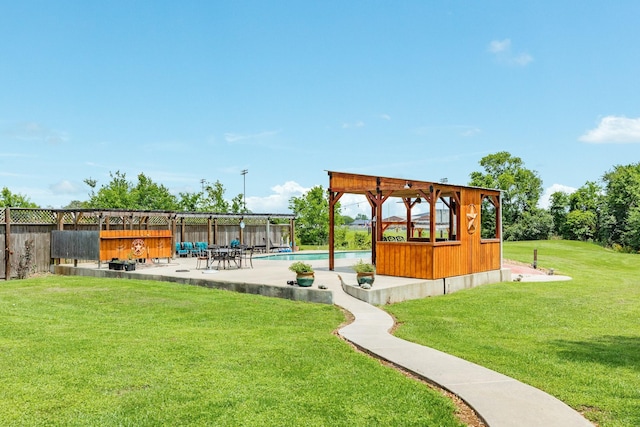 view of property's community with a lawn, fence, a patio, and a swimming pool