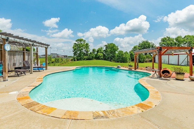 pool with a pergola, a patio area, fence, and a yard