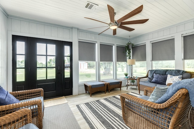 sunroom / solarium featuring ceiling fan, french doors, visible vents, and outdoor lounge area