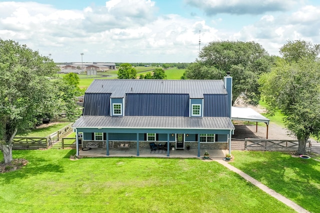 rear view of property featuring a yard, fence private yard, a patio area, and a chimney