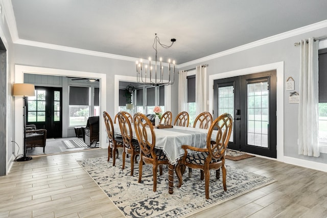 dining area with light wood finished floors, a wealth of natural light, and french doors