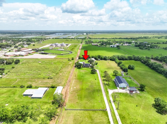 birds eye view of property with a rural view