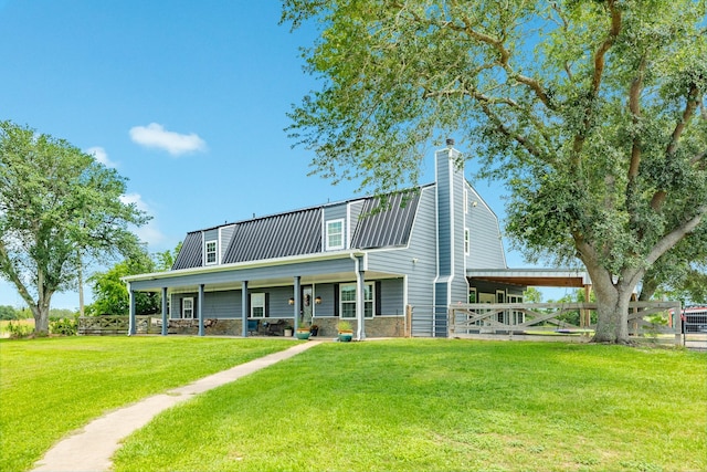 exterior space featuring a yard, fence, and metal roof