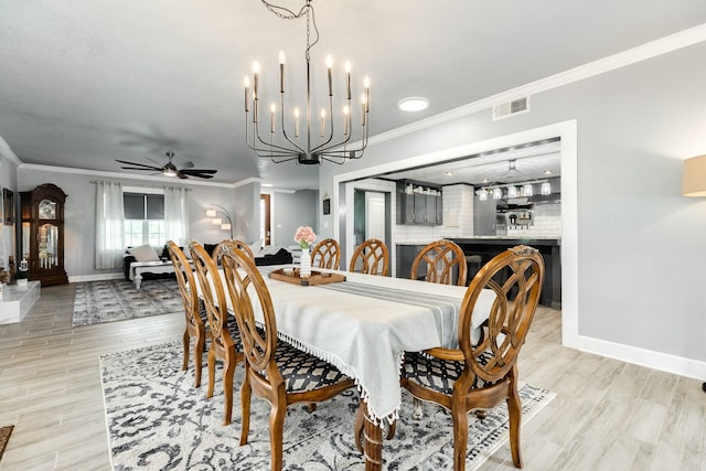 dining room featuring baseboards, ornamental molding, and visible vents