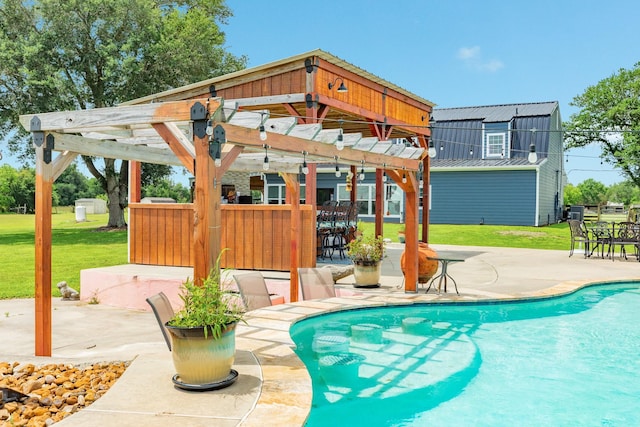 pool featuring outdoor dry bar, a patio area, and a lawn