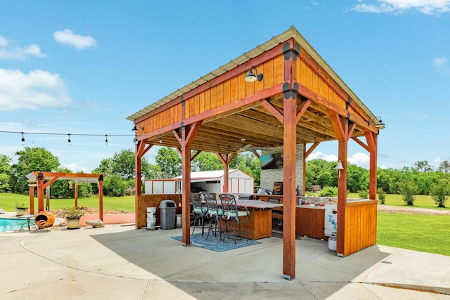 view of community with a yard, a patio, and outdoor dry bar
