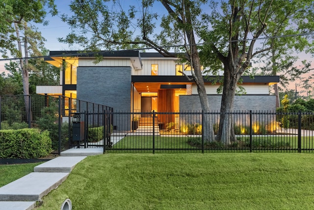 1900 W 14th St, Houston, TX 77008 - contemporary house with a gate, brick siding, a fenced front yard, a front lawn, and board and batten siding