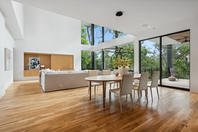 1900 W 14th St, Houston, TX 77008 - dining area with light wood finished floors, baseboards, and a high ceiling