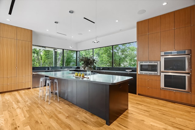 1900 W 14th St, Houston, TX 77008 - kitchen featuring a large island, appliances with stainless steel finishes, modern cabinets, and light wood-type flooring