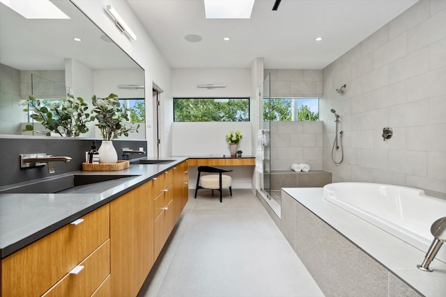 1900 W 14th St, Houston, TX 77008 - full bathroom with vanity, a stall shower, a skylight, and a garden tub