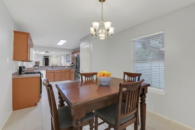 dining space featuring a notable chandelier, baseboards, and light tile patterned floors