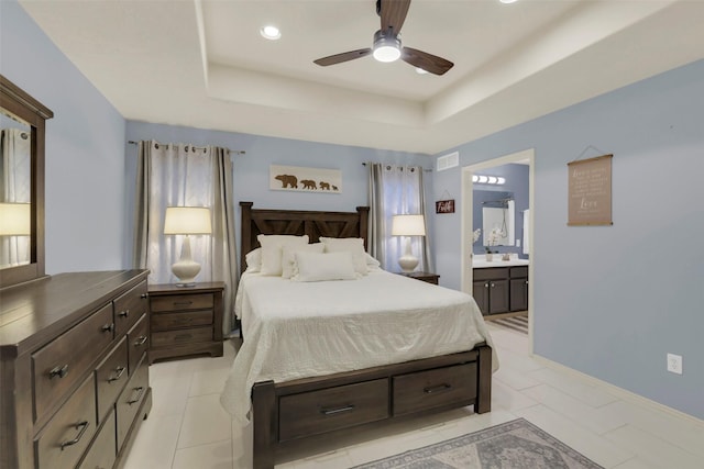 bedroom featuring a raised ceiling, connected bathroom, a ceiling fan, and recessed lighting