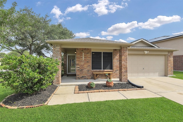 ranch-style home with covered porch, a garage, brick siding, and driveway