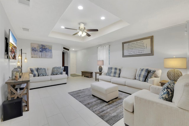 tiled living area with visible vents, a raised ceiling, ceiling fan, and recessed lighting