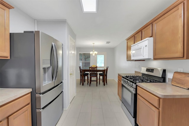 kitchen featuring an inviting chandelier, stainless steel appliances, hanging light fixtures, and light countertops
