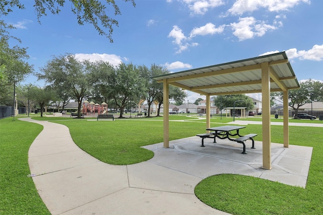 view of home's community with playground community and a yard