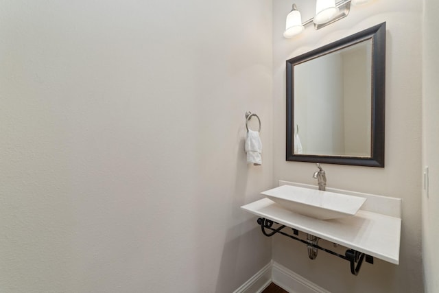 17803 Netherby Ln, Richmond, TX 77407 - bathroom featuring baseboards and a sink