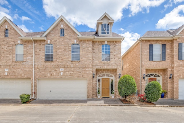 2827 Briarhurst Park, Houston, TX 77057 - view of front of house with roof with shingles, an attached garage, brick siding, and driveway